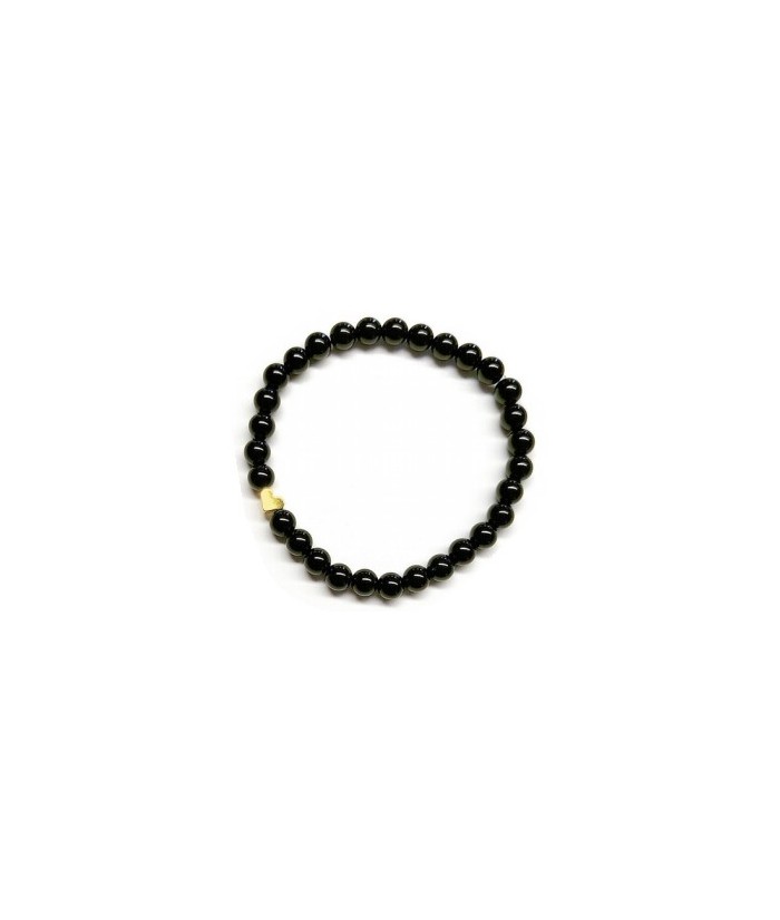 Pulsera de Ónix( bolas de 6mm) con símbolo de corazón dorado.

En goma elástica.

Tarjeta exclusiva en 3 idiomas.