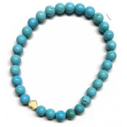 Pulsera de Turquenita (bolas de 6mm) con símbolo de corazón dorado.

En goma elástica.

Tarjeta exclusiva en 3 idiomas.