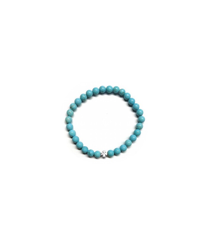 Pulsera de Turquenita (bolas de 6mm) con símbolo de trébol plateado.

En goma elástica.

Tarjeta exclusiva en 3 idiomas