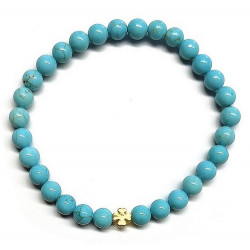 Pulsera de Turquenita (bolas de 6mm) con símbolo de trébol dorado.

En goma elástica.

Tarjeta exclusiva en 3 idiomas.
