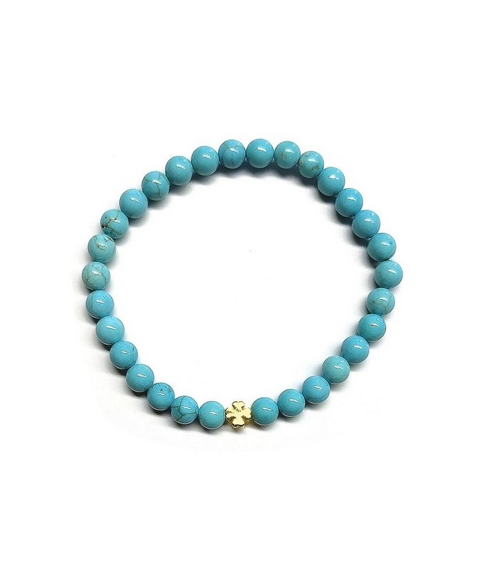 Pulsera de Turquenita (bolas de 6mm) con símbolo de trébol dorado.

En goma elástica.

Tarjeta exclusiva en 3 idiomas.