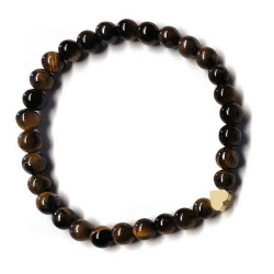 Pulsera de Ojo de Tigre (bolas de 6mm) con símbolo de corazón dorado.

En goma elástica.

Tarjeta exclusiva en 3 idiomas.